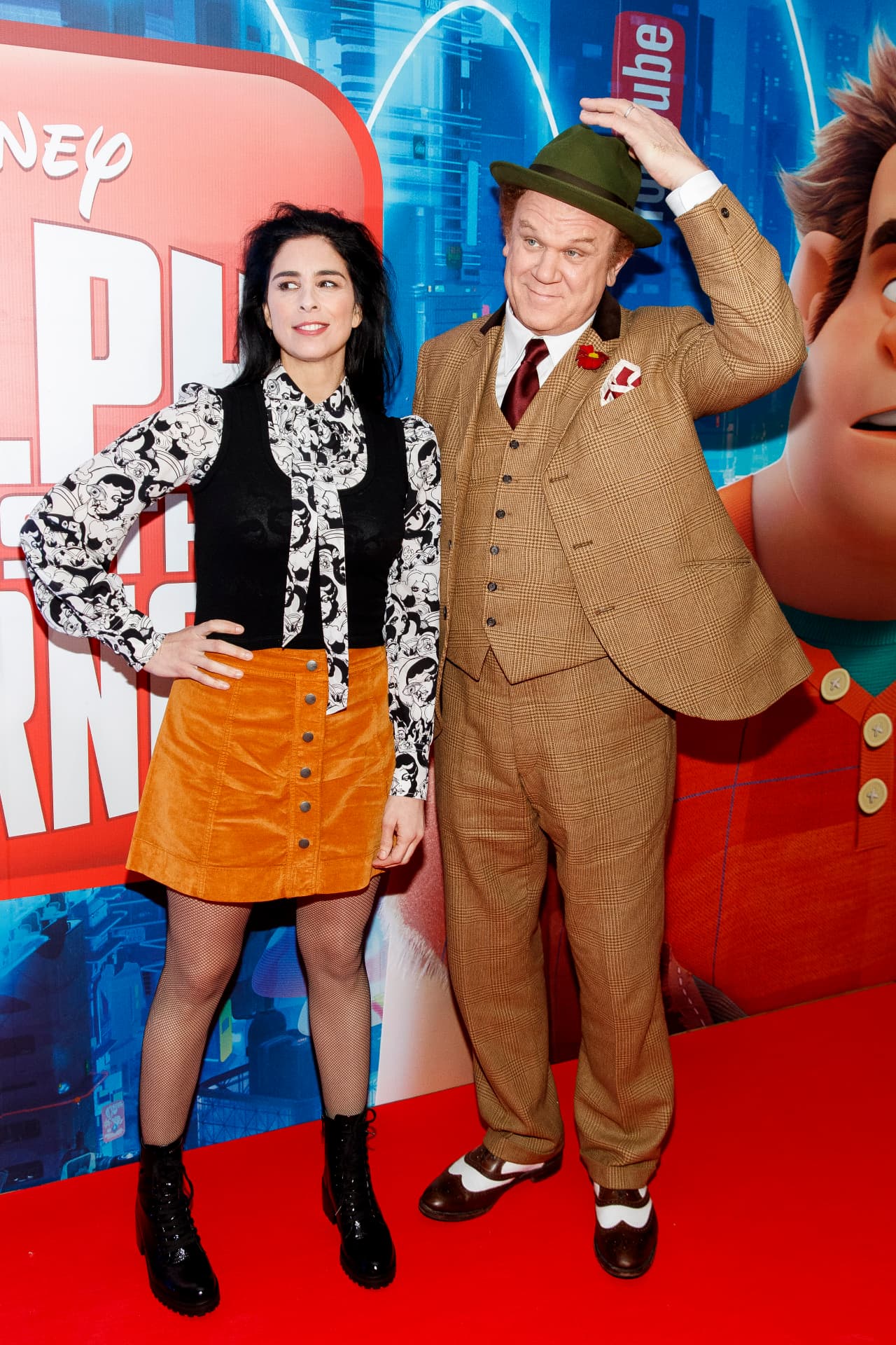 Two guests posing together in front of the Disney Ralph Breaks the Internet premiere backdrop